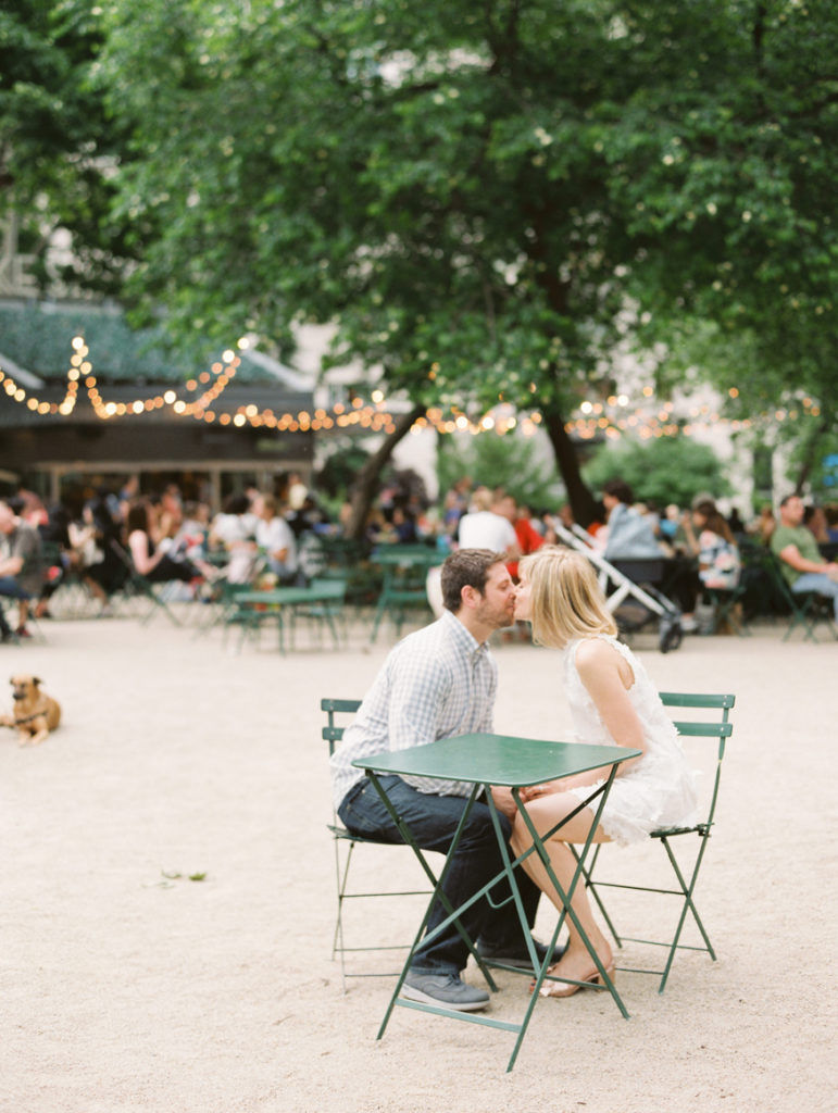 Couple sitting and kissing in Madison Square Park next to Shake Shack | Mary Dougherty