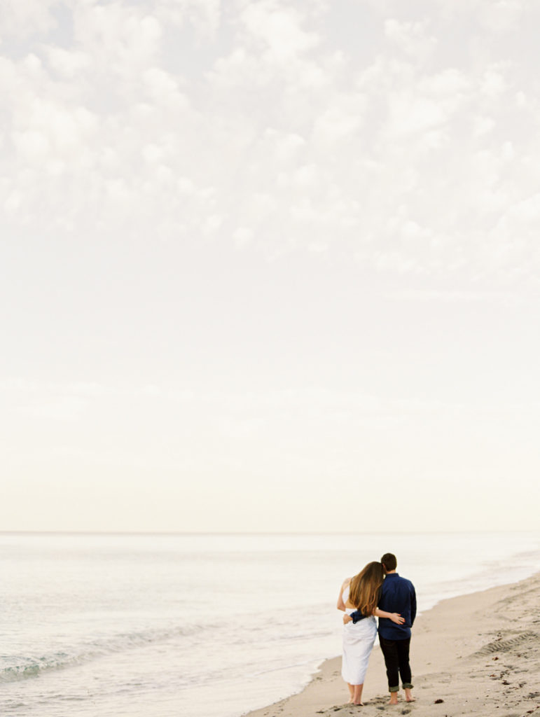 couple standing on Delray beach looking out to ocean | Mary Dougherty