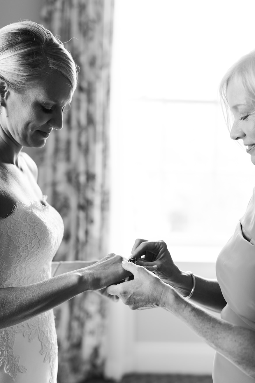 bride and mom putting on vintage heirloom ring | Mary Dougherty black and white image