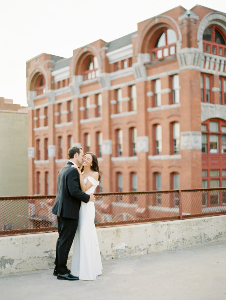 bride and groom kiss on rooftop Sky Armory Wedding Syracuse NY | Mary Dougherty