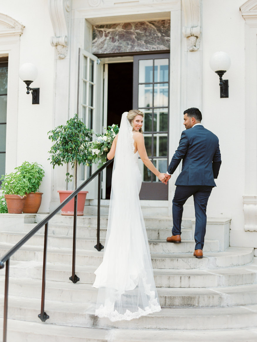 Modern Estate Wedding bride and groom walk up stairs long veil | Mary Dougherty