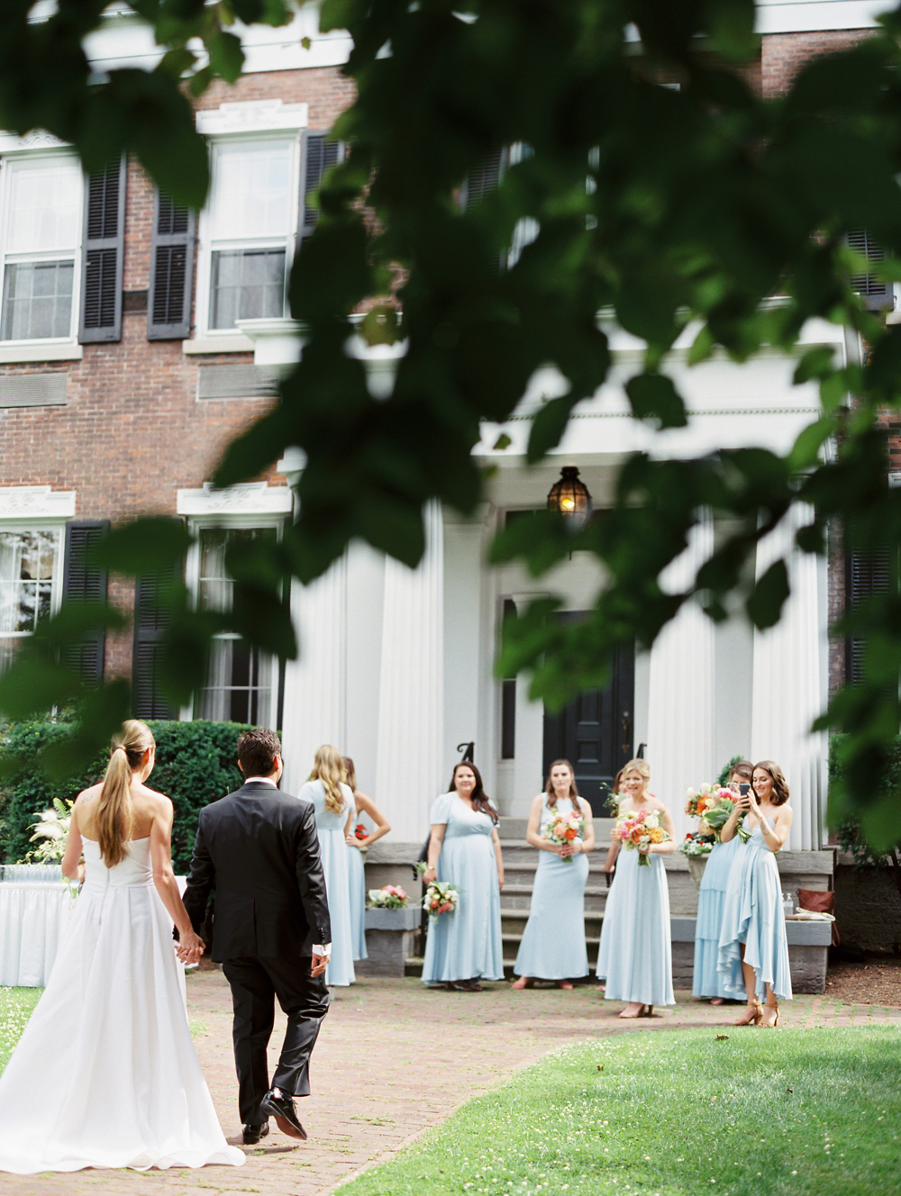 bride and groom walk with group of friends at Genesee Valley Club in rochester New York | Mary Dougherty