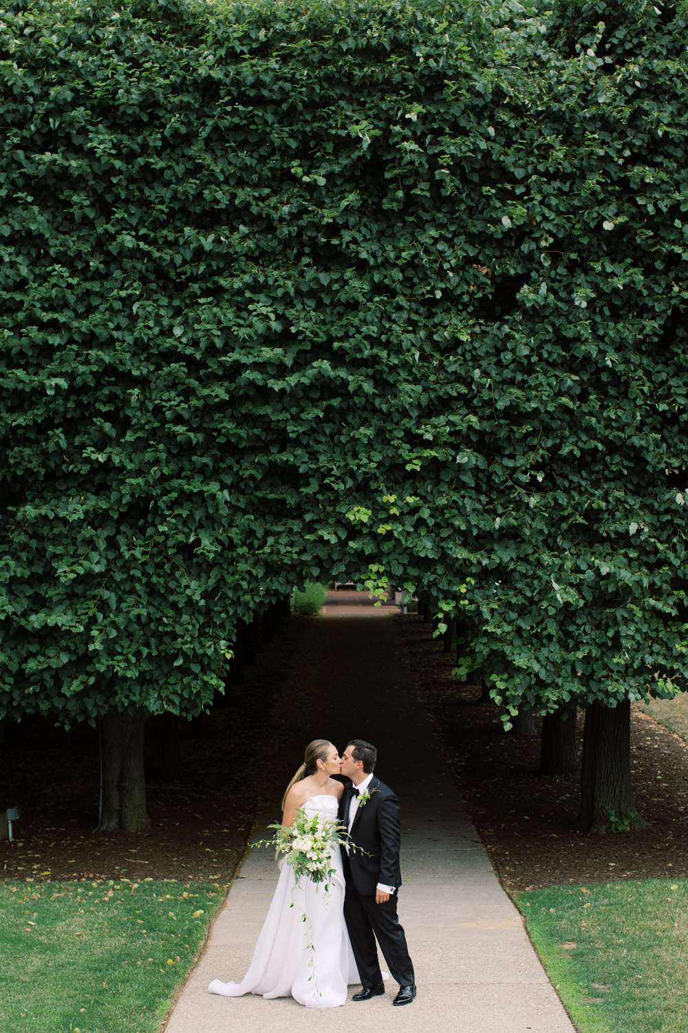 Memorial Art Gallery Linden Trees with Bride and Groom kissing | Mary Dougherty