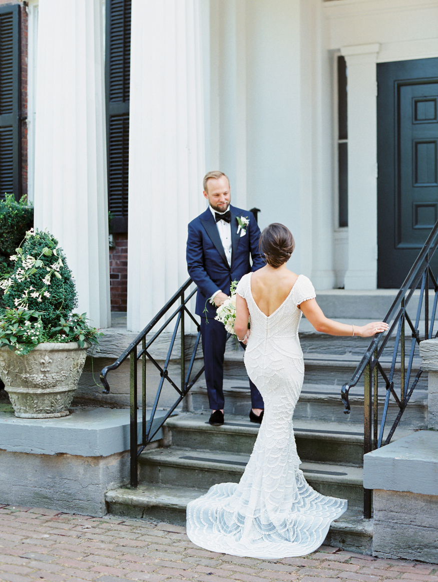 Rochester NY outdoor wedding venue the Genesee Valley Club with bride and groom standing on stairs | Mary Dougherty Photography