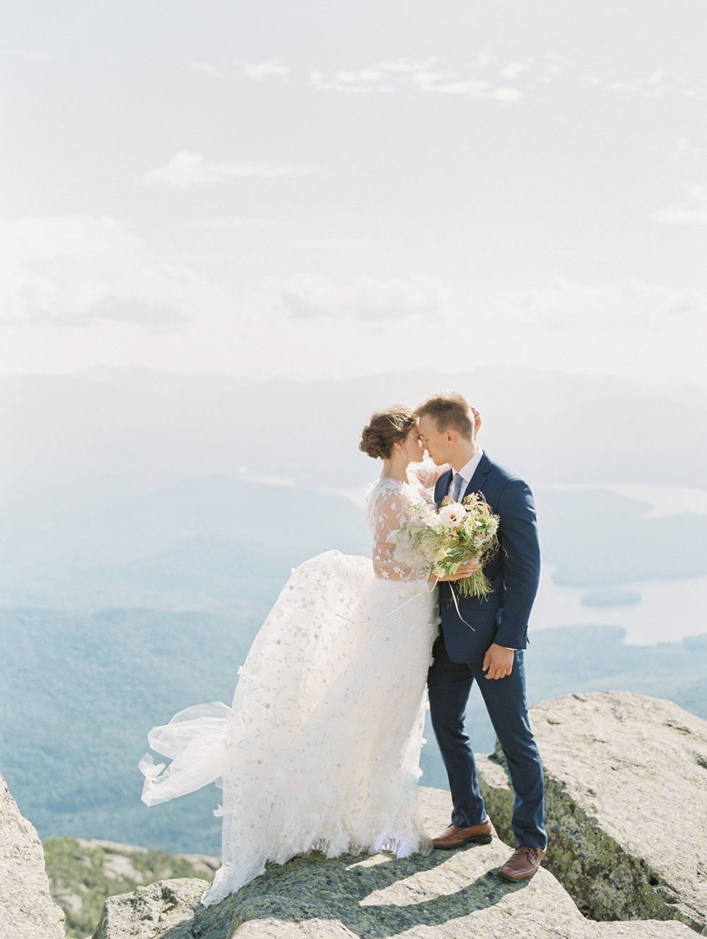 Mary Dougherty Workshop | Bride and Groom standing on top of Whiteface Mountain in Lake Placid New York midday Marchesa wedding dress