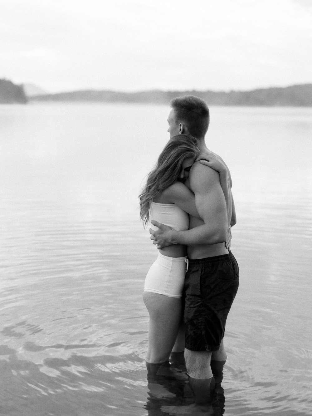 Couple stands in lake and embraces bw image of Adirondack honeymoon at the Point by Mary Dougherty Photography