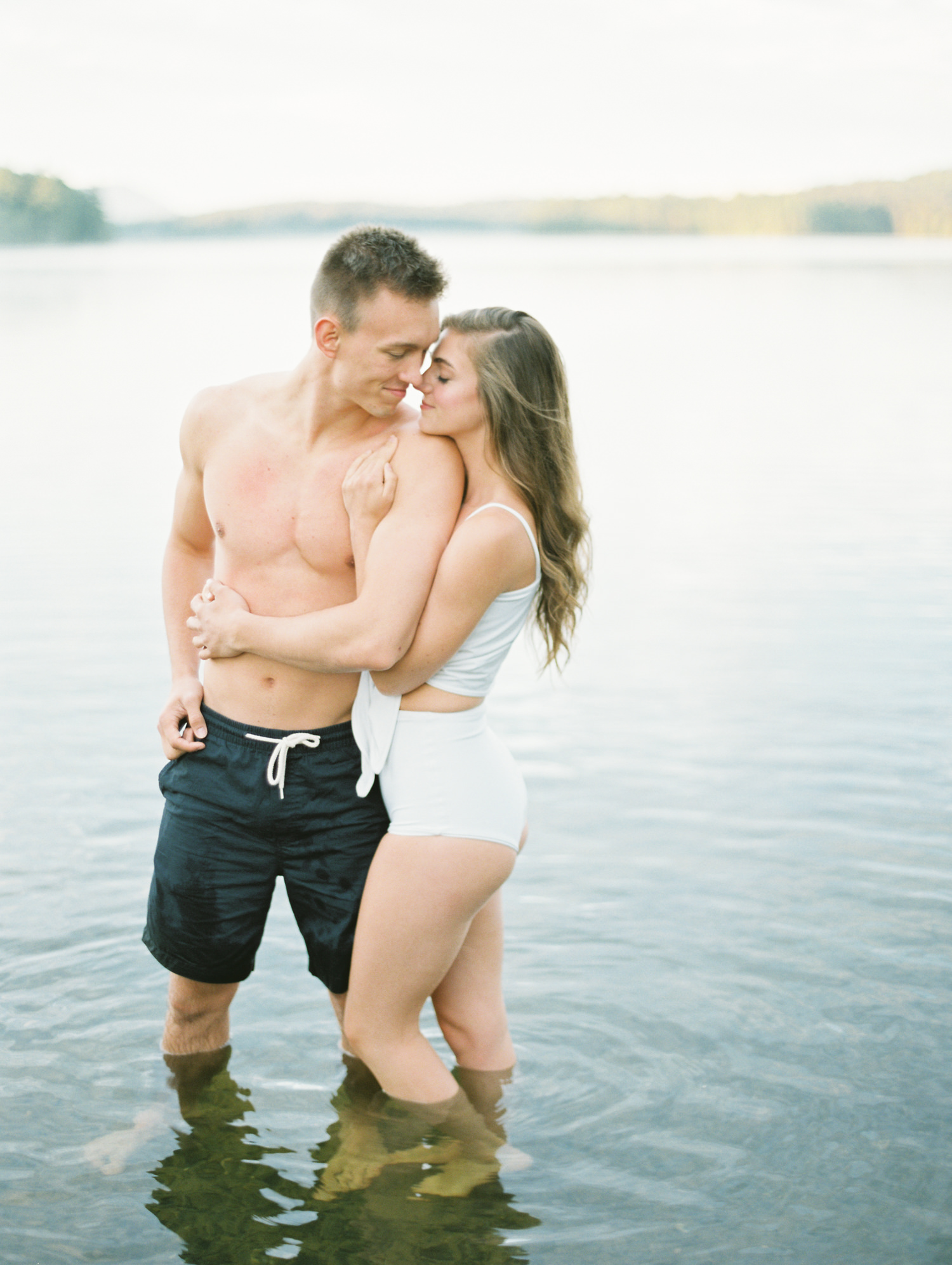Lake Placid couple stands in water for a kiss in the Adirondacks | Mary Dougherty Photography