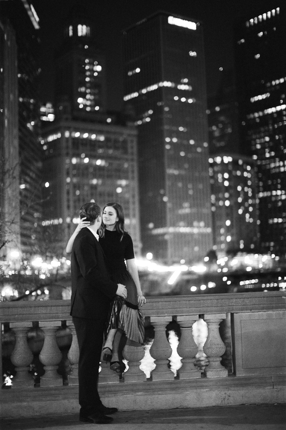 Chicago in bw at night city lights with romantic moment for engaged couple Mary Dougherty