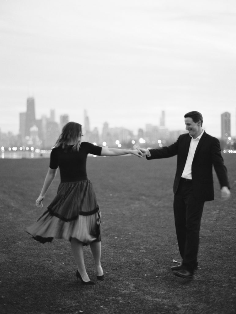 classic couple dances in bw film with chicago skyline behind them by Mary Dougherty