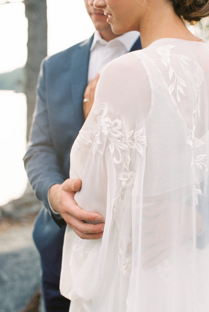 close photo of couple holding each other soft colors wedding cape long bohemian dress | Adirondack Island Elopement | Mary Dougherty