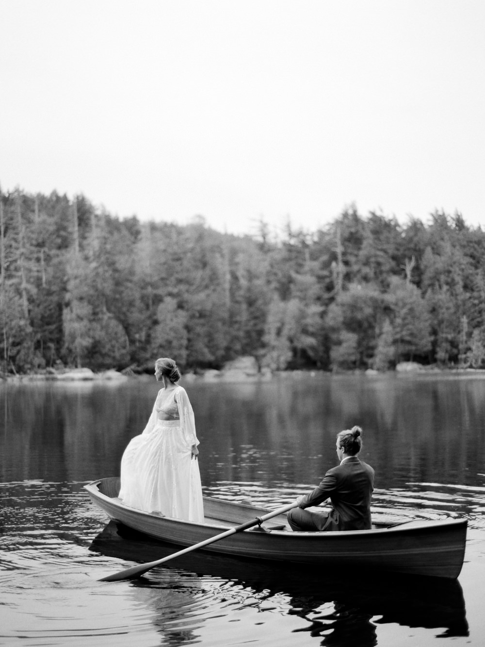 bw photo of couple in row boat paddling to elope in Adirondacks by Mary Dougherty | film photography workshop