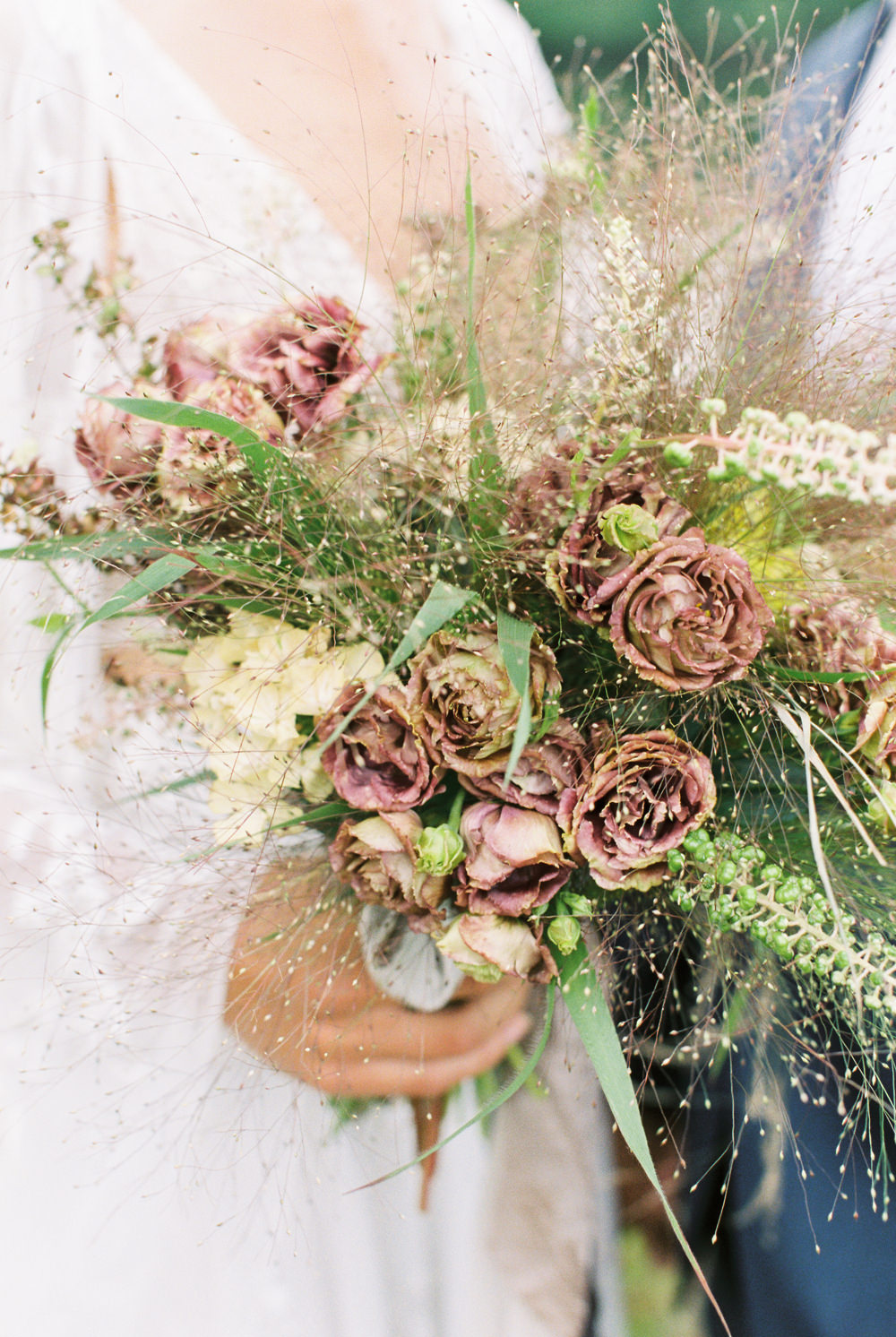 textured wedding bouquet close up with mauve roses and foraged greenery for Adirondack wedding workshop by Mary Dougherty