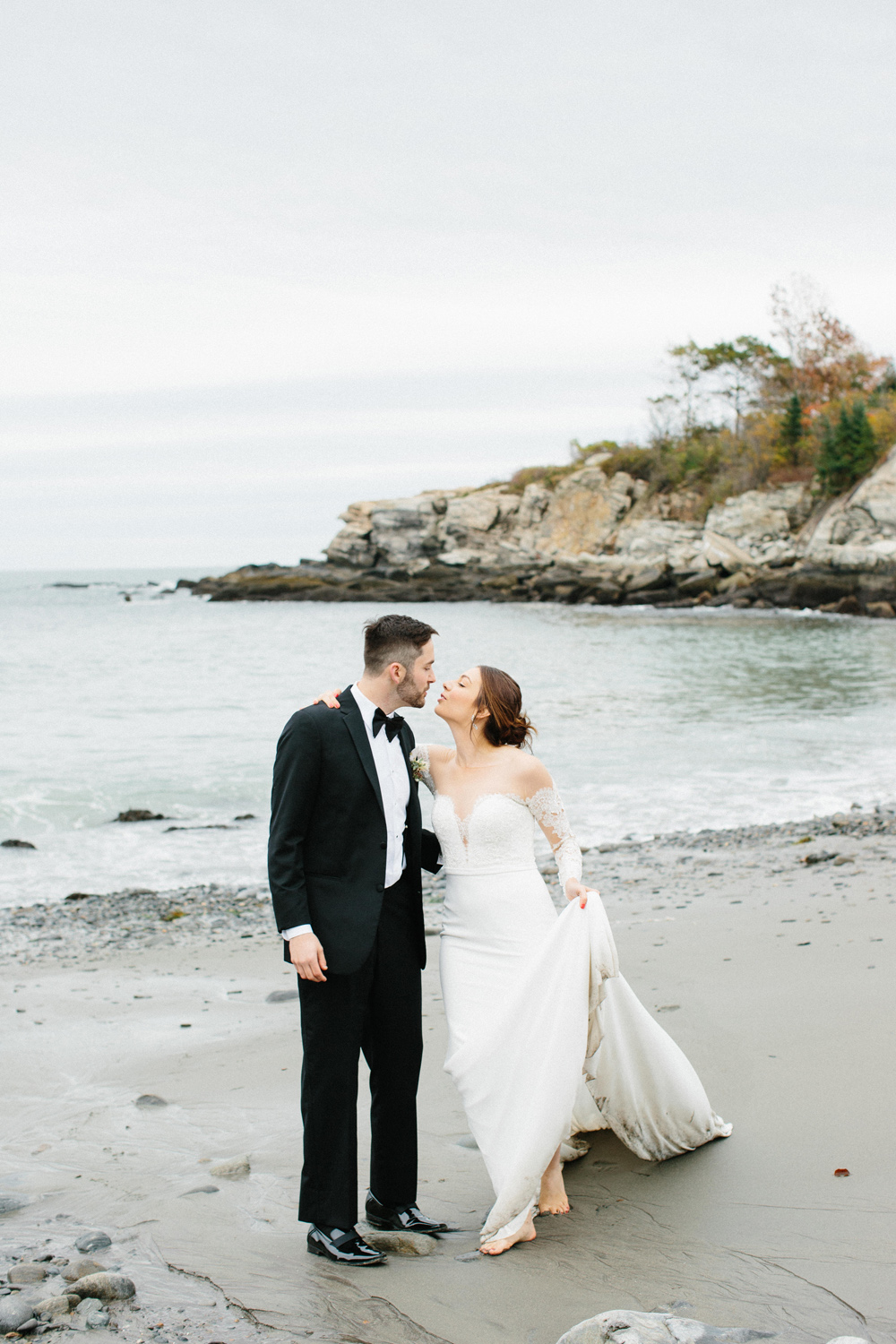 bride and groom almost kiss at Portland Head Light Beach during their Maine fall elopement | Mary Dougherty 