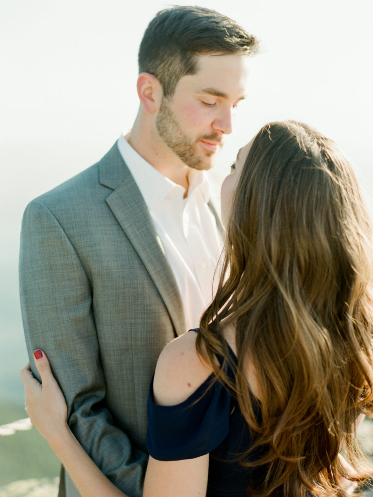 couple looks at each other in whiteface mountain engagement session photo by Mary Dougherty