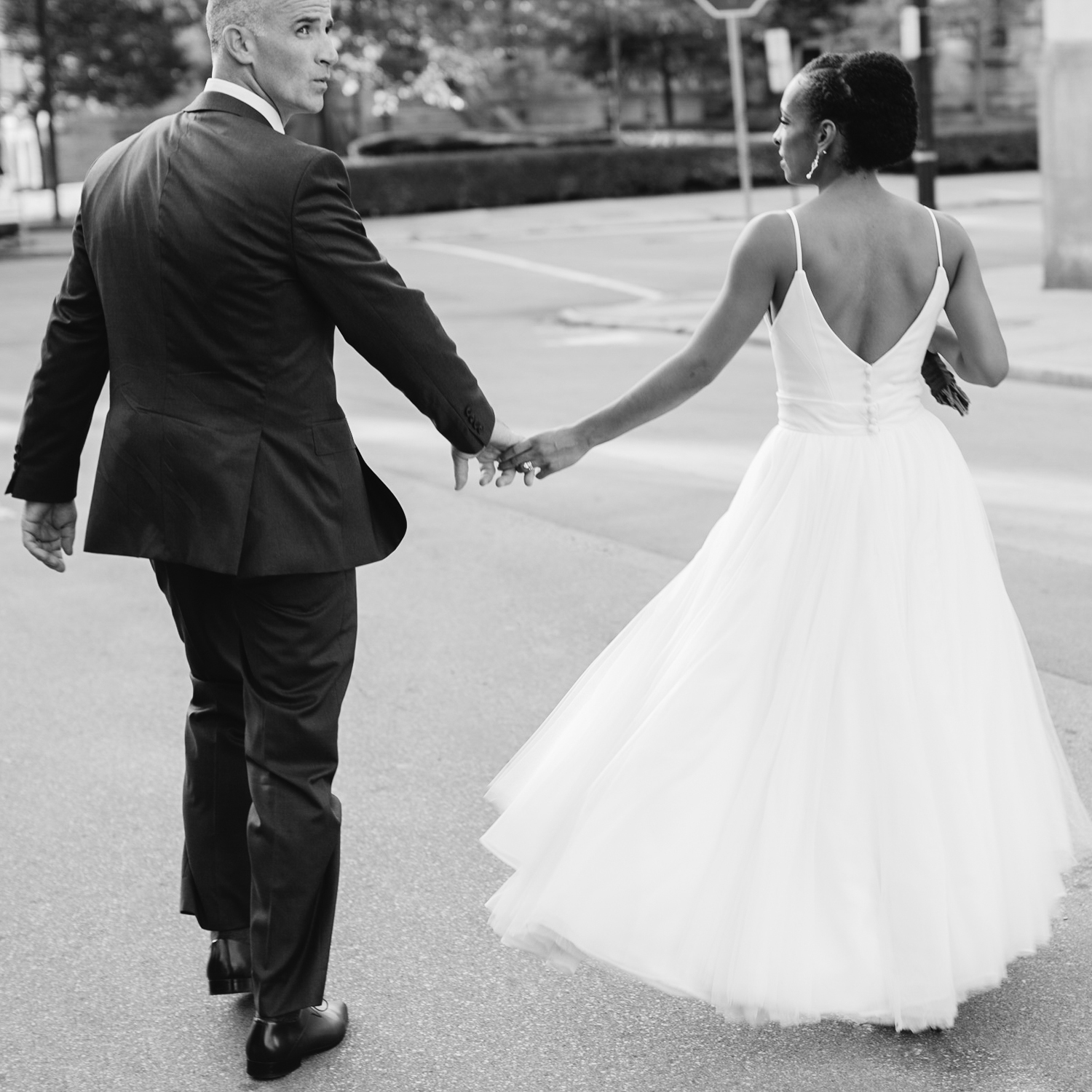 Candid photo of bride and groom walking down road after wedding | Mary Dougherty
