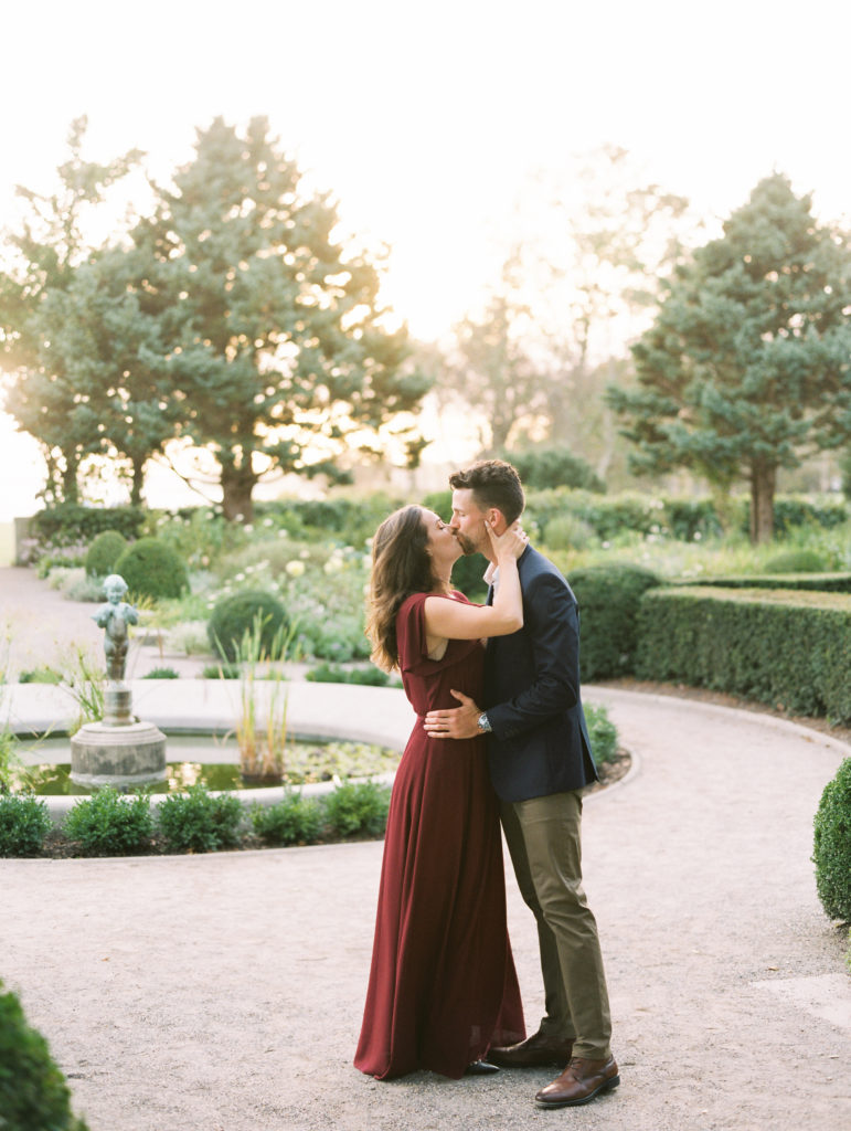 Couple kisses in the gardens at the Eolia Harkness Mansion | Mary Dougherty destination film wedding photographer