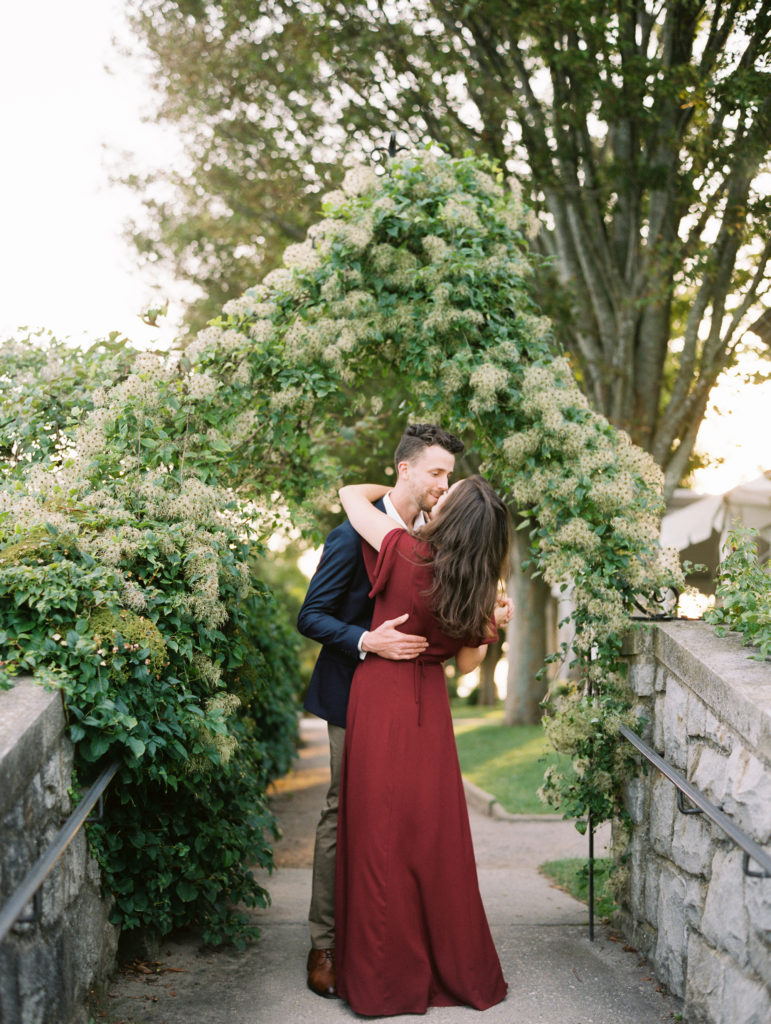 Couple embracing in front of the Eolia Harkness Mansion in Waterford, CT | Mary Dougherty destination film wedding photographer