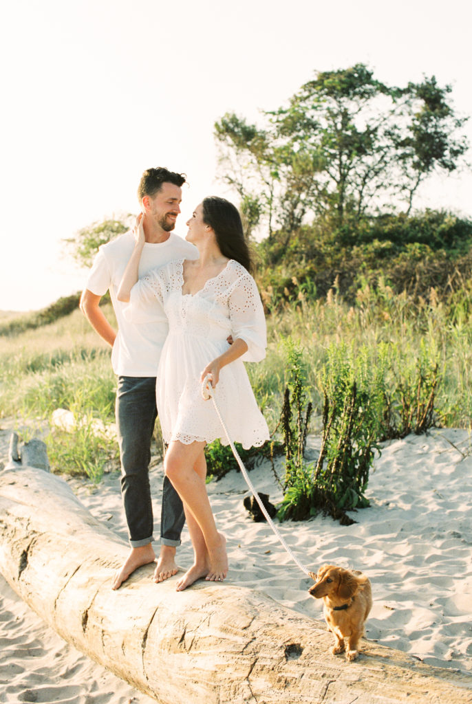 Casual beach engagement photos with a dog