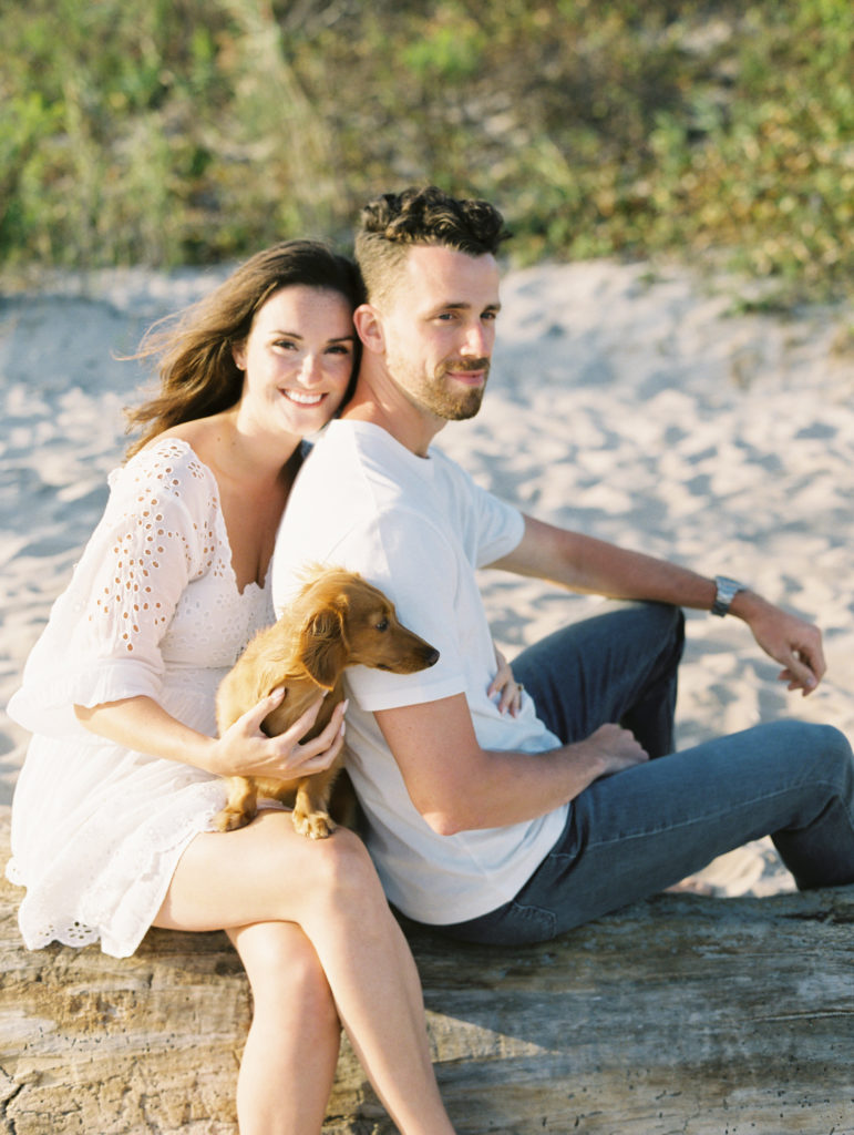 Young couple with a dog on the beach