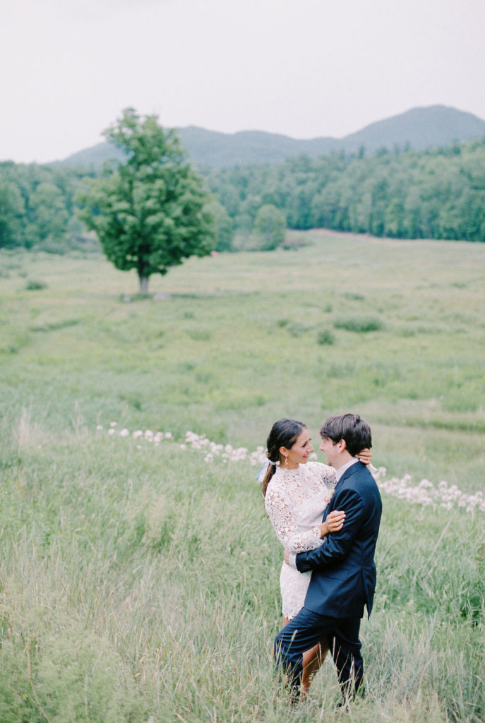 Adirondack Elopement | bride and groom stand in field overlooking meadow | Mary Dougherty