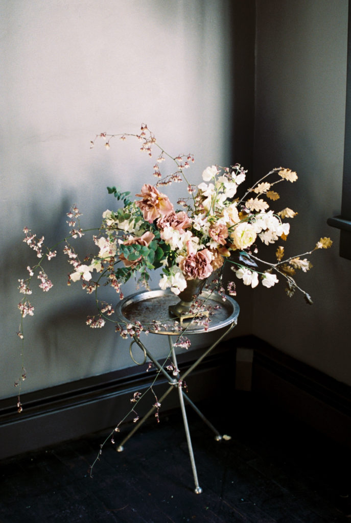 organic Floral arrangement sits in moody room Foxfire Mountain House photographed by Mary Dougherty