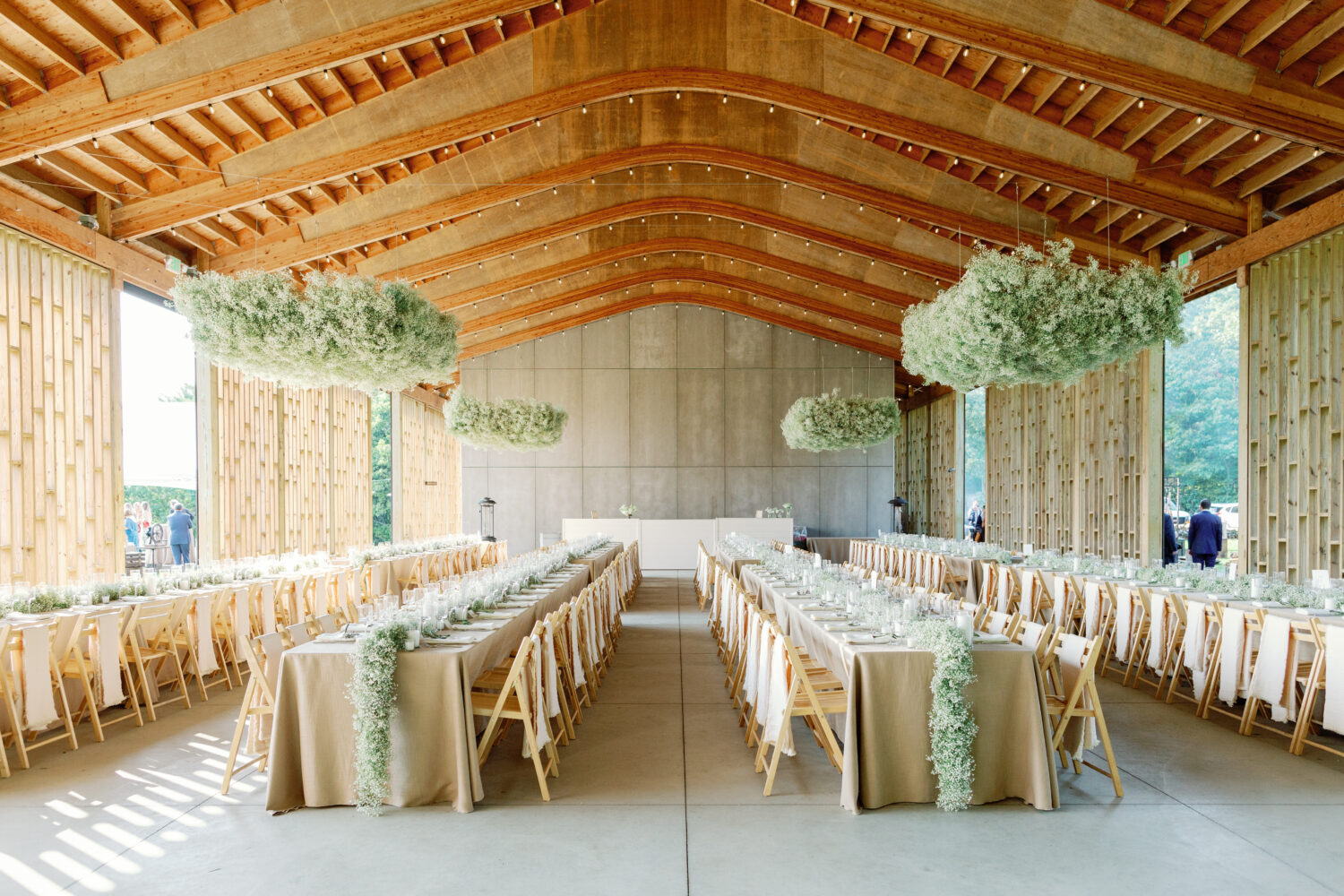 Gather Greene Wedding Pavilion reception design with long tables and floral clouds